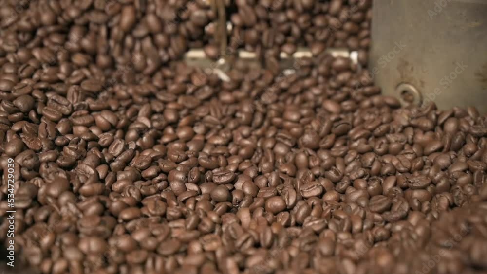 Close up brown coffee bean roasting in a coffee roasting machine with rotating metal arm in slow motion. Close up brown coffee bean roasting in a coffee roasting machine with rotating metal arm in slow motion.