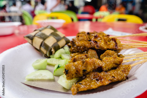 Satay - Malaysia and Singapore traditional hawker food,  seasoned, skewered and grilled meat, served with a sauce.