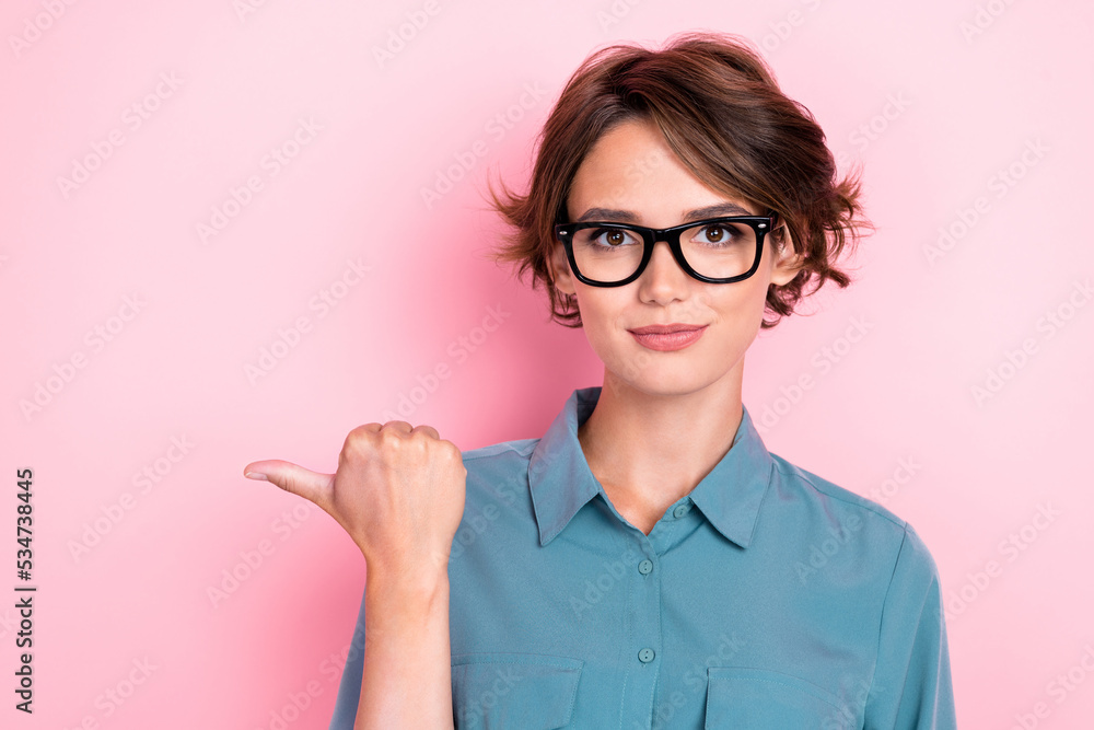 Portrait of pretty good mood woman with bob hairdo wear blue blouse eyeglasses directing empty space isolated on pink color background Portrait of pretty good mood woman with bob hairdo wear blue blouse eyeglasses directing empty space isolated on pink color background
