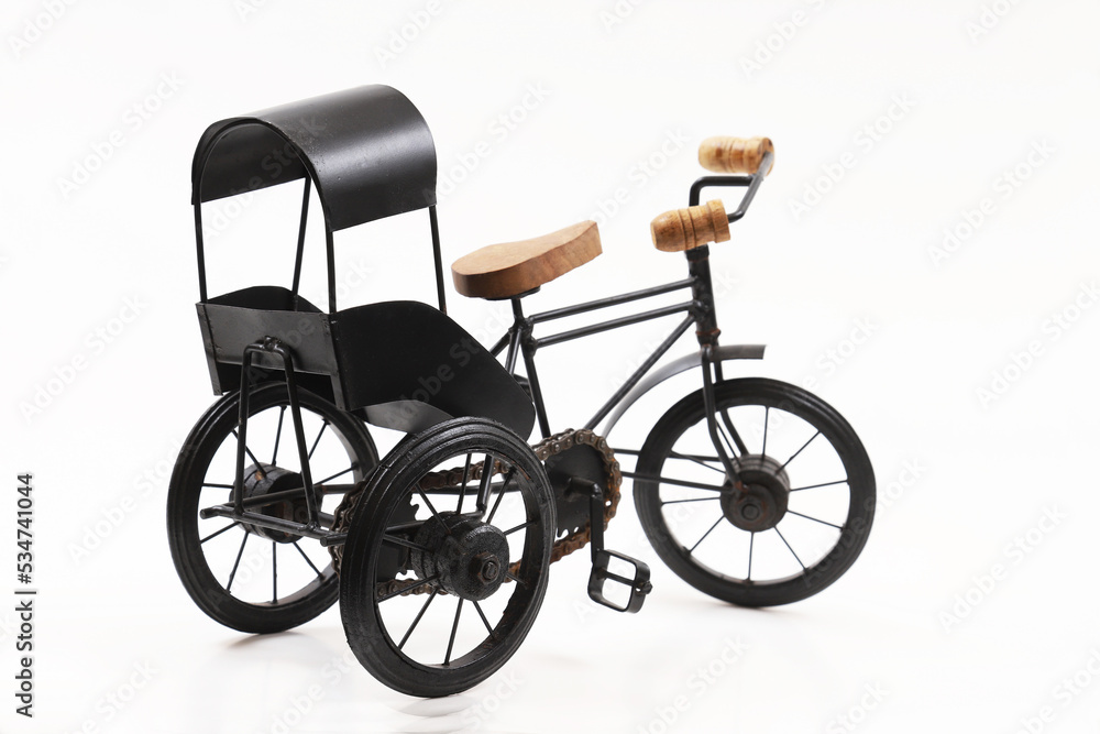 Decorative souvenir bike. Antique tricycle-carriage. Shallow depth of field