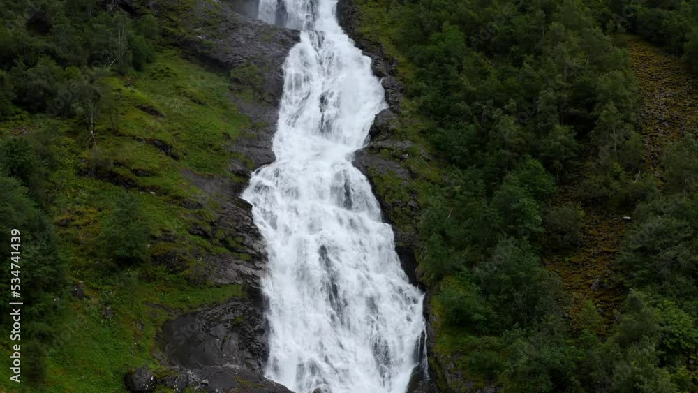 waterfall formed from the melting of glaciers in the mountains, the water of a beautiful turquoise color scatter over the stone slope waterfall formed from the melting of glaciers in the mountains, the water of a beautiful turquoise color scatter over the stone slope