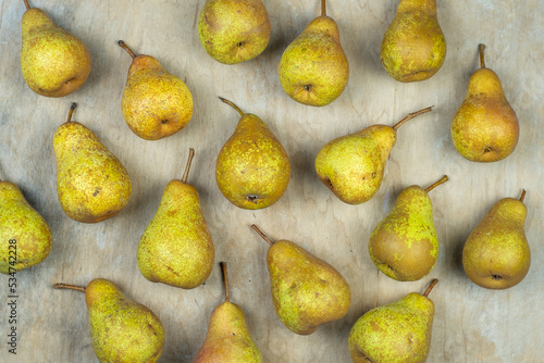 Pears on a wooden background. Fruit harvest. Autumn still life. Pear variety Bera Conference. Vitamin food.