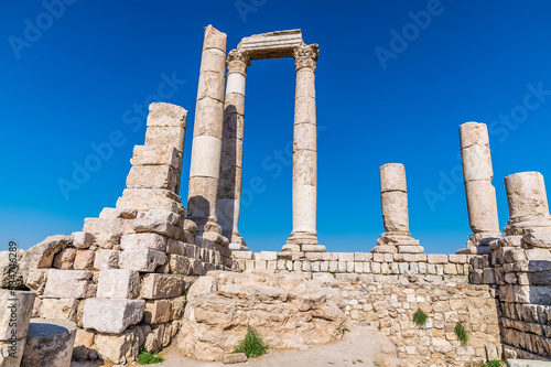 A close up of the front columns and wall of the Temple of Hercules in the citadel in Amman, Jordan in summertime