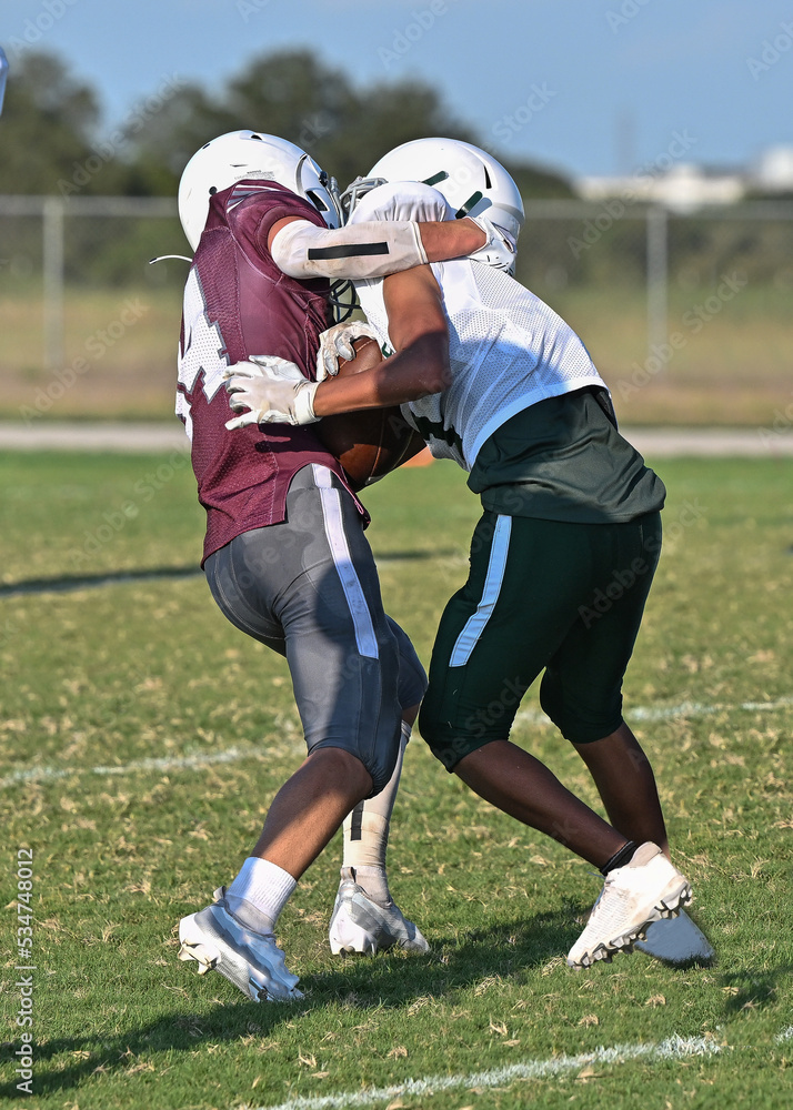 Young athletic tackle football players making great plays during a game