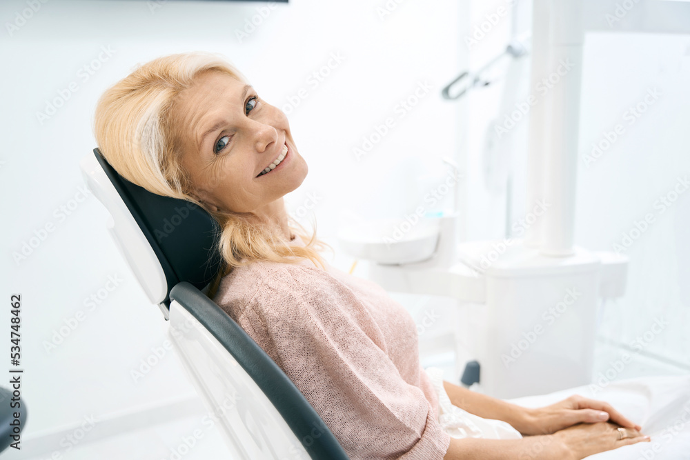 Pretty woman sitting at the dental cabinet Pretty woman sitting at the dental cabinet