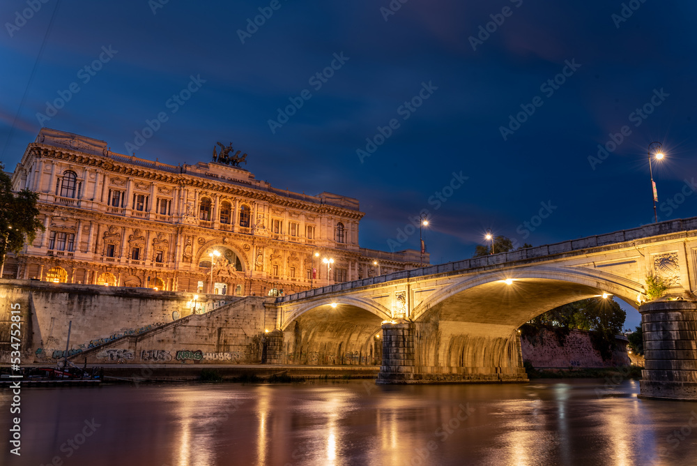 Long Exposition of the Building of the Court of Cassation and a Bridge of the Tevere River Illuminated by Lights at the Blue Hour in the Center of Rome