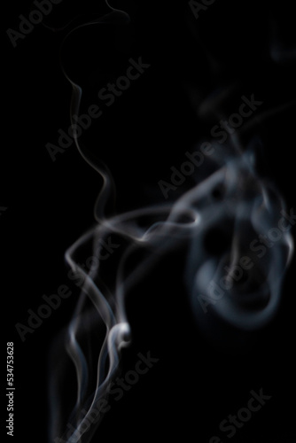 White smoke on black background for layer overlay effect. A realistic smoke or fog effect for photo and video manipulation effect and mystery design theme