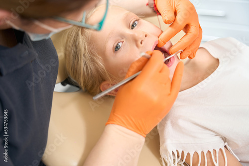 Doctor dentist conducts a complete examination of the teeth of a girl