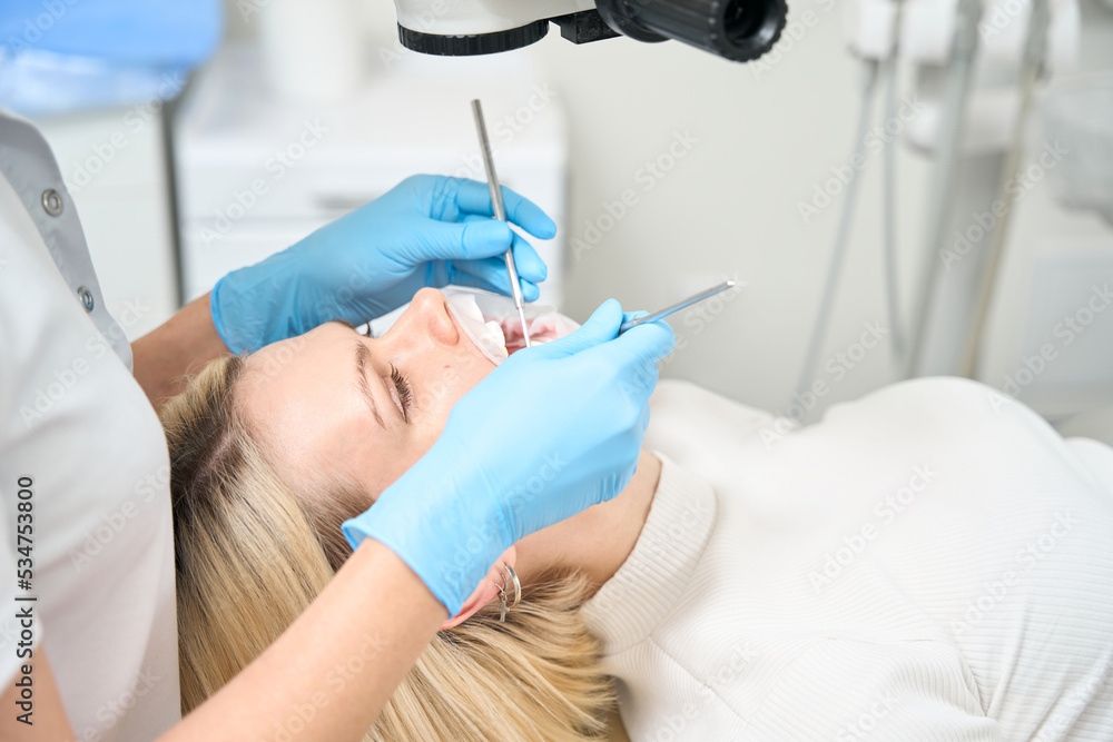 Dentist examines a patient in the office Dentist examines a patient in the office