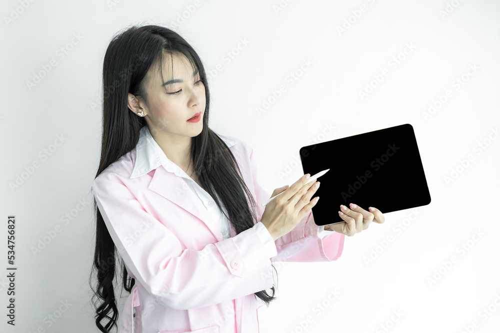Asian woman doctor hand holding tablet gadget pointing and presenting with copy space on white background, Asian woman doctor in pink coat with digital tablet, Medical and healthcare. Asian woman doctor hand holding tablet gadget pointing and presenting with copy space on white background, Asian woman doctor in pink coat with digital tablet, Medical and healthcare.