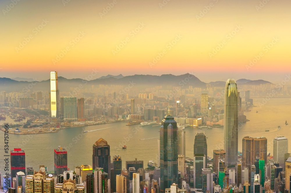 View of Victoria Harbor and Hong Kong skyline at sunset.