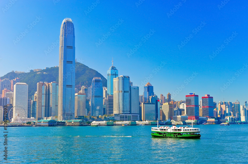 Fototapeta premium View of Victoria Harbor and Hong Kong skyline on a sunny day.