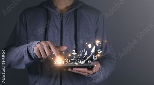 Startup concept with icon business, graph and network connection on modern virtual interface from digital smart phone. man touching on smartphone. online business, e-comers, online marketing