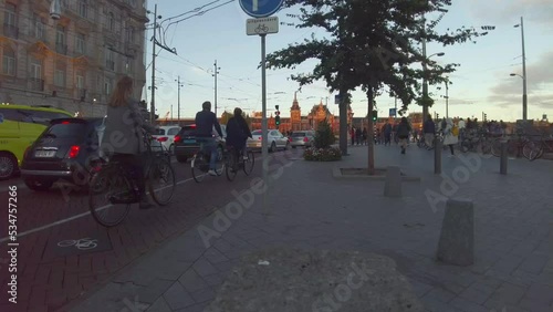 Amsterdam central train station plaza before sunset, time lapse crowded people and traffic jam, wide angle