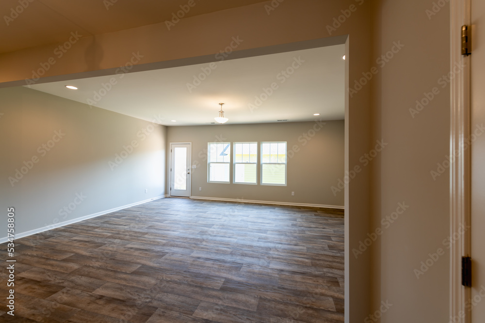 Empty dinning room in a townhouse with ceiling fan, a door, and window. Empty dinning room in a townhouse with ceiling fan, a door, and window.