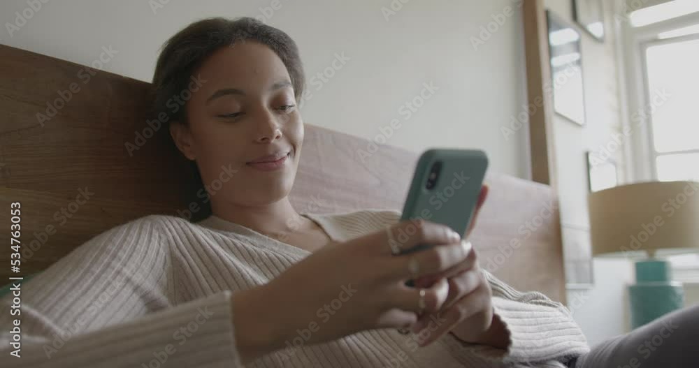 Young Adult Female using Phone in Bedroom, Scrolling Social Media Young Adult Female using Phone in Bedroom, Scrolling Social Media