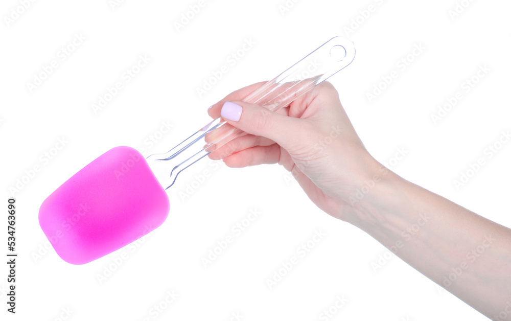 Pink silicone spatula in hand on white background isolation Pink silicone spatula in hand on white background isolation