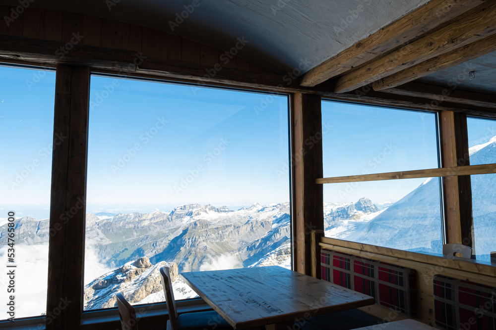 Indoor shot of the table decoration inside of the restaurant that have exotic scenery of Titlis ice mountain in Switzerland during summer season. Travel destination, no people.