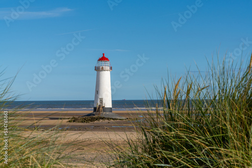 the Point of Ayr lighthouse in North Wales with reeds and grasses in the foreground