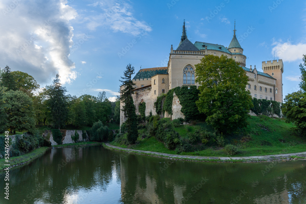 view of the Bojnice Castle with reflections in the moat
