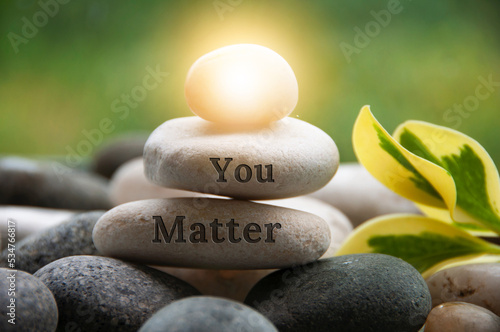 Фототапет Light shining on zen stone with customizable space for text