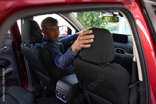 Man sits in the driver's seat half-turned © Svitlana