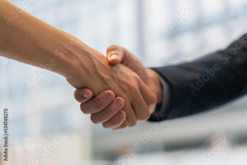 Businessmen making handshake in the city - business etiquette, congratulation.