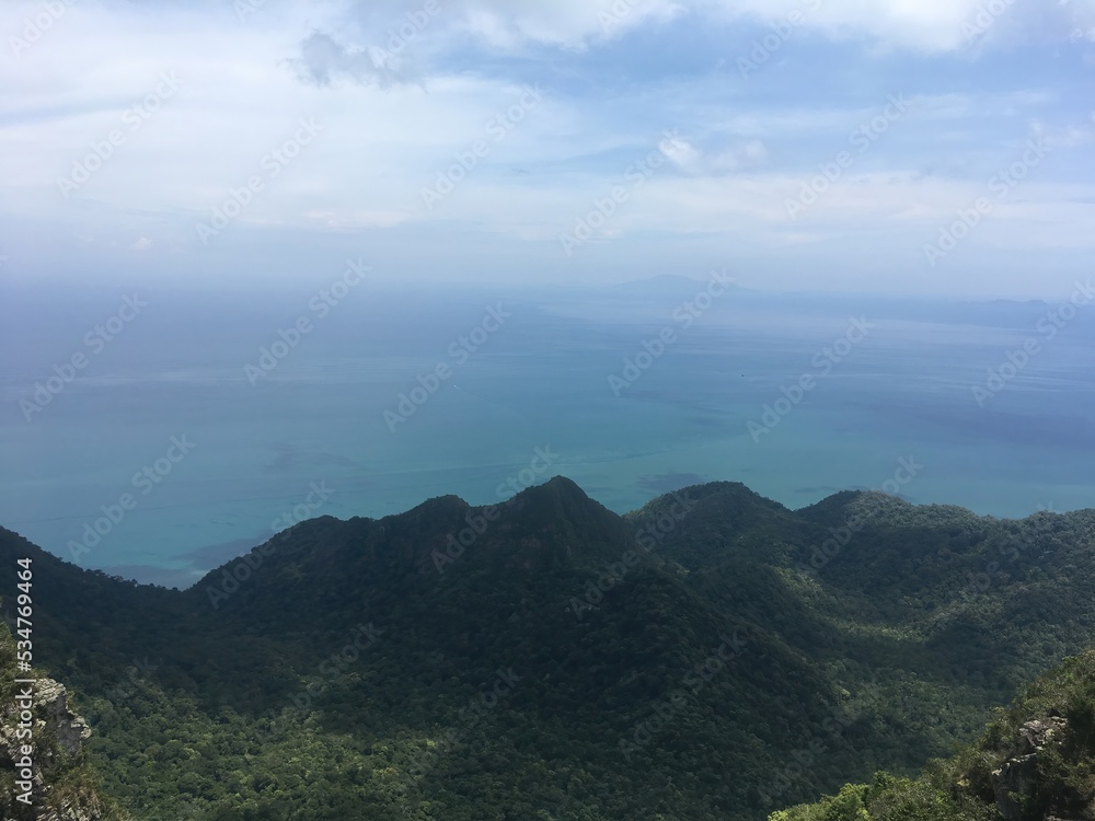 Bird's eye view of the sea and green hills