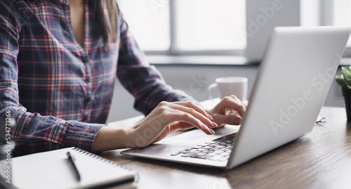 Woman working in office, female hands typing on computer keyboard closeup, businesswoman or student girl using laptop at home, online learning, internet marketing, office workplace, freelance concept