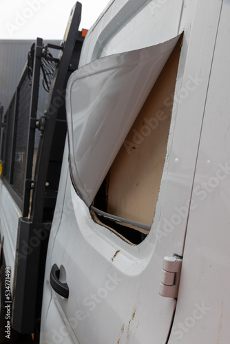 Broken vehicle door lock. Side panel cut with angle grinder.  White van damaged by a thief. Example of rural crime and vehicle crime in the UK.