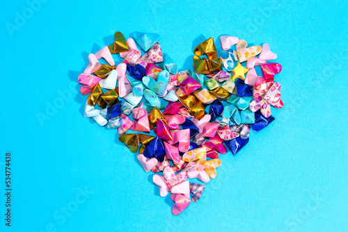 heart made of colorful paper on blue background