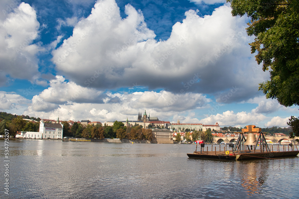 The Commemorative bell #9801 on a pontoon in the Vltava river at Smetanovo nábřeží. Prague. Prague Castle and Charles bridge in behind.