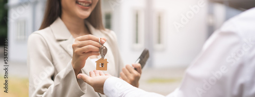 Bild auf Leinwand Sell agent, asian young woman giving key apartment to new owner, tenant after signed rental, lease contract with buyer man with landlord, realtor house