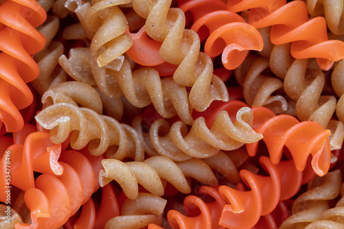 Whole, lentils fusilli pasta background.