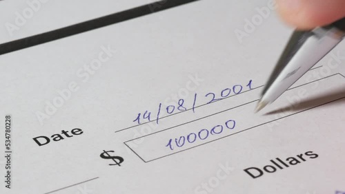 Write a check in dollars for ten million dollars. A man writes a check for $10,000,000 million. Payment by check, write out the cash form on paper. photo