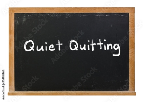 Quiet Quitting written in white chalk on a black chalkboard isolated on white