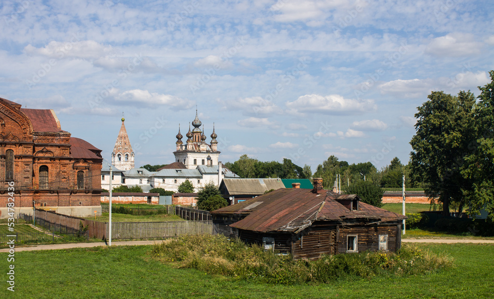 Panoramic view of the old town of Yuriev-Polsky in the Vladimir region with ancient churches and houses among the green grass on a sunny summer day Panoramic view of the old town of Yuriev-Polsky in the Vladimir region with ancient churches and houses among the green grass on a sunny summer day