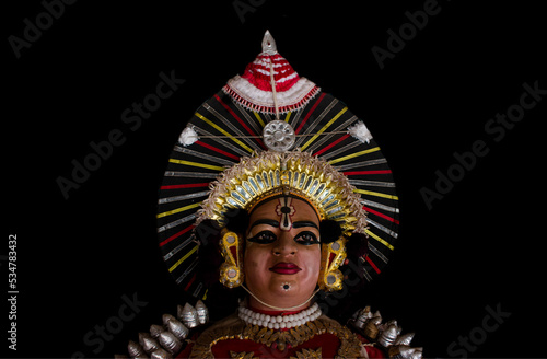 Statue of Yakshagana dace artist isolated on black background. Yakshagana is a traditional folk dance of India. photo