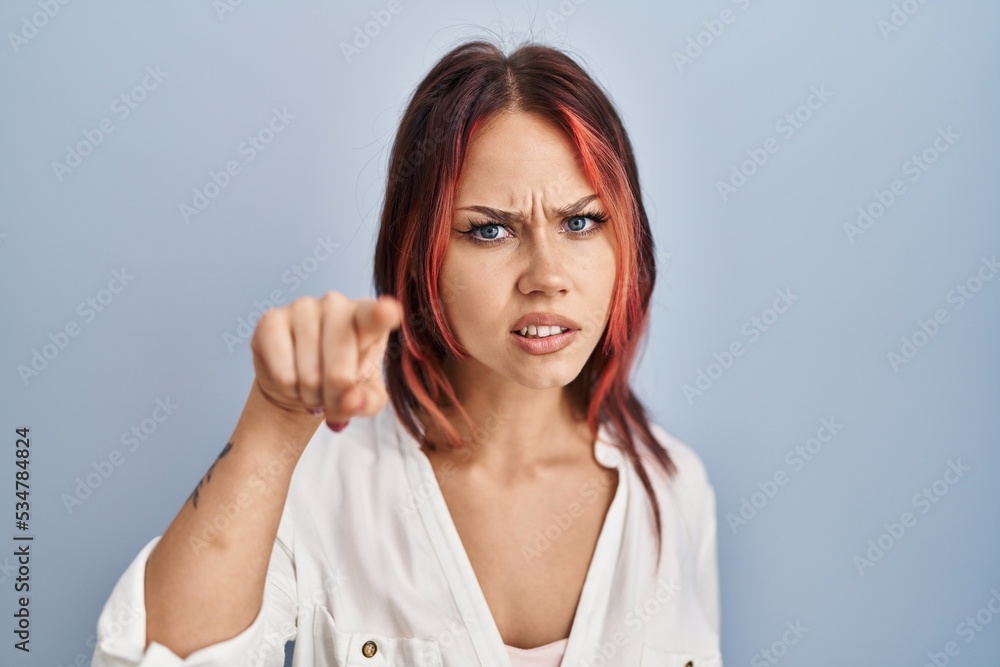 Young caucasian woman wearing casual white shirt over isolated background pointing displeased and frustrated to the camera, angry and furious with you Young caucasian woman wearing casual white shirt over isolated background pointing displeased and frustrated to the camera, angry and furious with you
