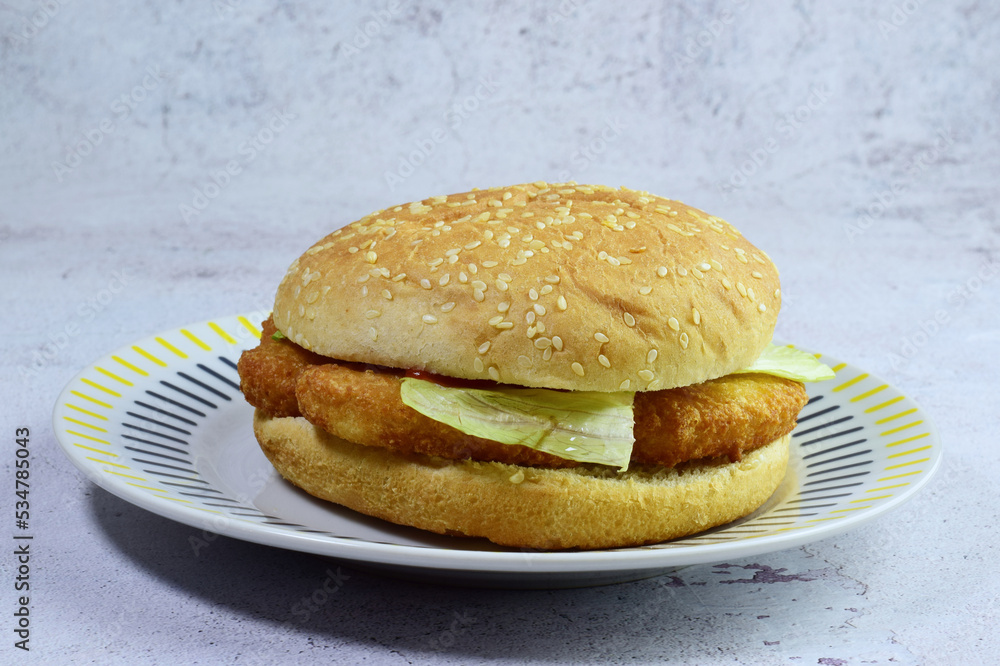 Close up, bread with seeds, chicken nuggets, ketchup and lettuce. Close up, bread with seeds, chicken nuggets, ketchup and lettuce.