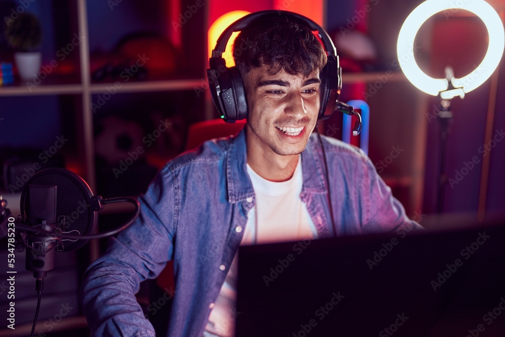 Young hispanic man streamer playing video game using computer at gaming room Young hispanic man streamer playing video game using computer at gaming room