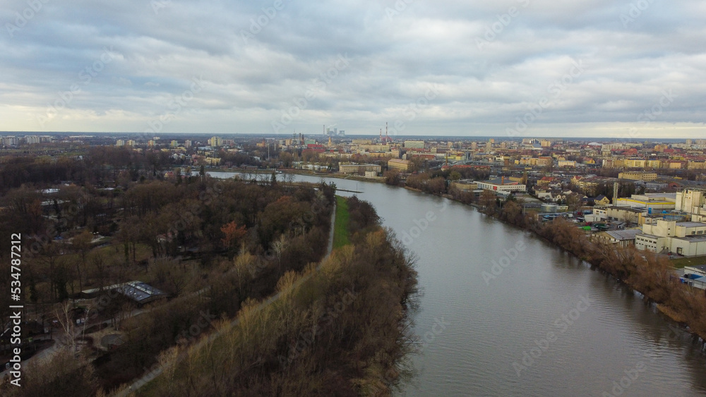 Top view of the city Opole. The Odra River flows through the city, dry trees on the banks. In the background of the house. Poland