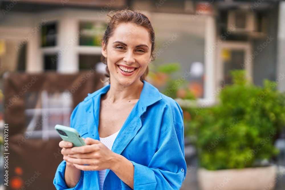 Young woman smiling confident using smartphone at street Young woman smiling confident using smartphone at street