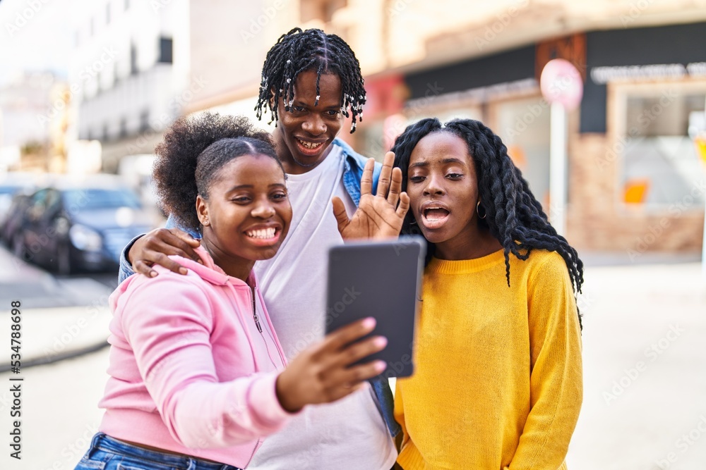 Obraz premium African american friends standing together having video call at street