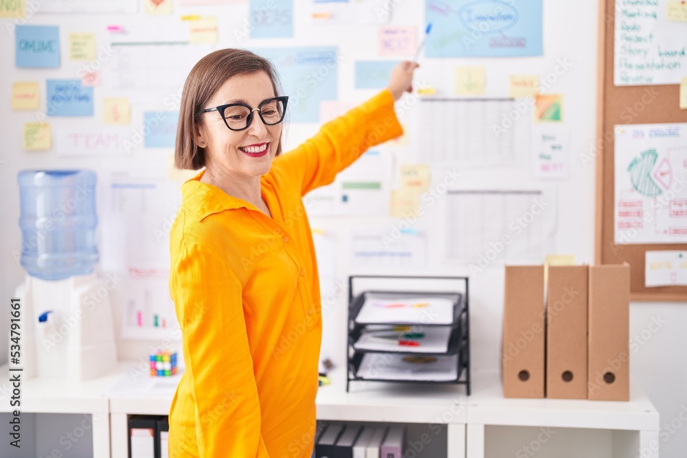 Middle age woman business worker smiling confident speaking at office Middle age woman business worker smiling confident speaking at office