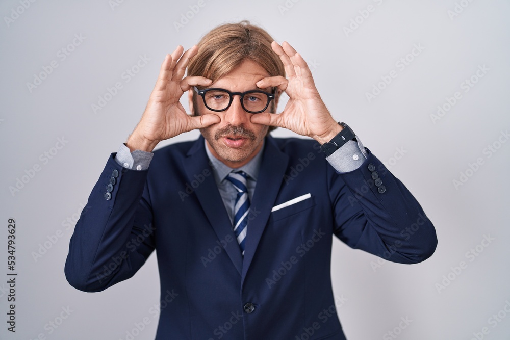 Caucasian man with mustache wearing business clothes trying to open eyes with fingers, sleepy and tired for morning fatigue Caucasian man with mustache wearing business clothes trying to open eyes with fingers, sleepy and tired for morning fatigue