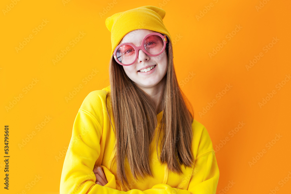 portrait of young pretty hipster woman wearing yellow hats and glasses.