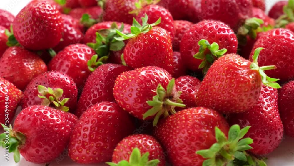Strawberry on a white background. Strawberry background. Red fresh strawberry wallpaper. Macro. Texture. Frame with copy space. Lots of freshly picked Berries rotating on turntable. Close up. 4K Strawberry on a white background. Strawberry background. Red fresh strawberry wallpaper. Macro. Texture. Frame with copy space. Lots of freshly picked Berries rotating on turntable. Close up. 4K