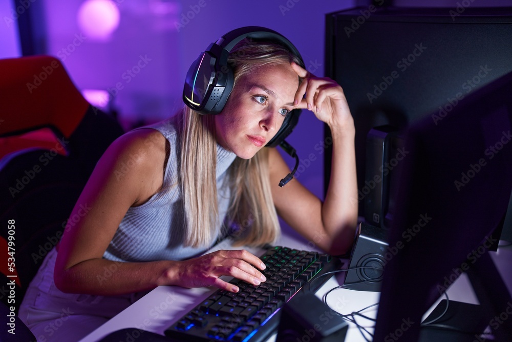 Young blonde woman streamer stressed using computer at gaming room Young blonde woman streamer stressed using computer at gaming room