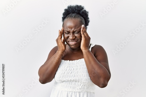 Young african woman standing over white isolated background with hand on head, headache because stress. suffering migraine.